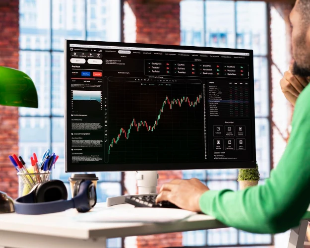 AMML investment analyst in West Africa meticulously analyzing financial market data and charts on a computer screen, demonstrating a disciplined approach to value creation.