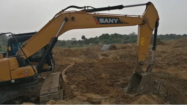Heavy excavator machinery working on an African mining site, representing AMML's active investment and operations in the West African Mining Industry.