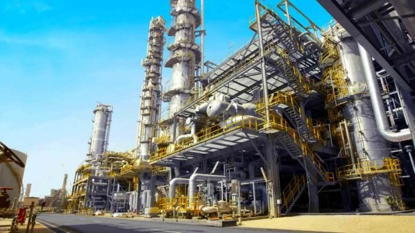 Large-scale oil refinery and processing infrastructure under a clear sky, symbolizing AMML's strategic investments in the West African Oil Industry and energy sector.